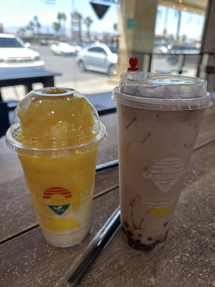 Dusty Milo dusted with chocolate malt powder, next to a mango slushy
