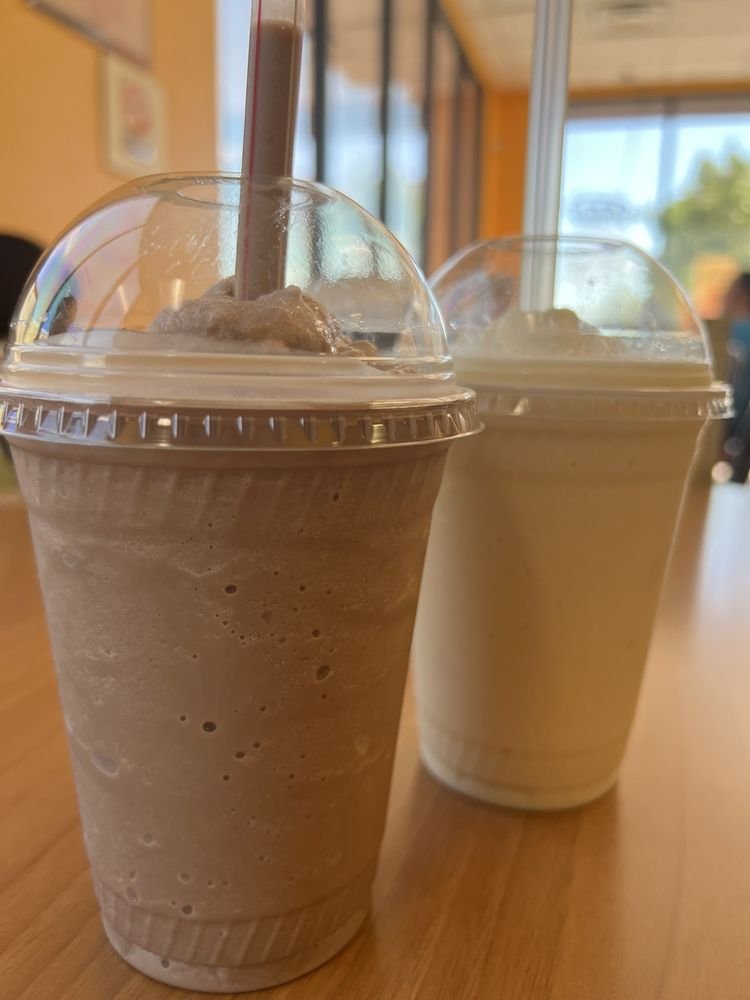 Two fresh fruit smoothies in tall cups