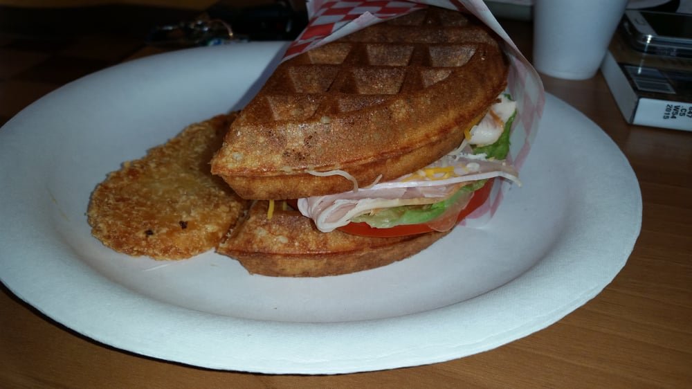 Turkey waffle sandwich with a hash brown on the side
