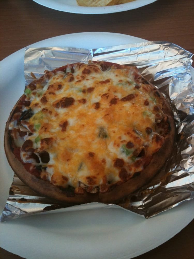 Vegetarian waffle pizza topped with peppers, onions, olives and mushrooms
